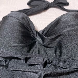 Halter neckline. Molded inner cup.
